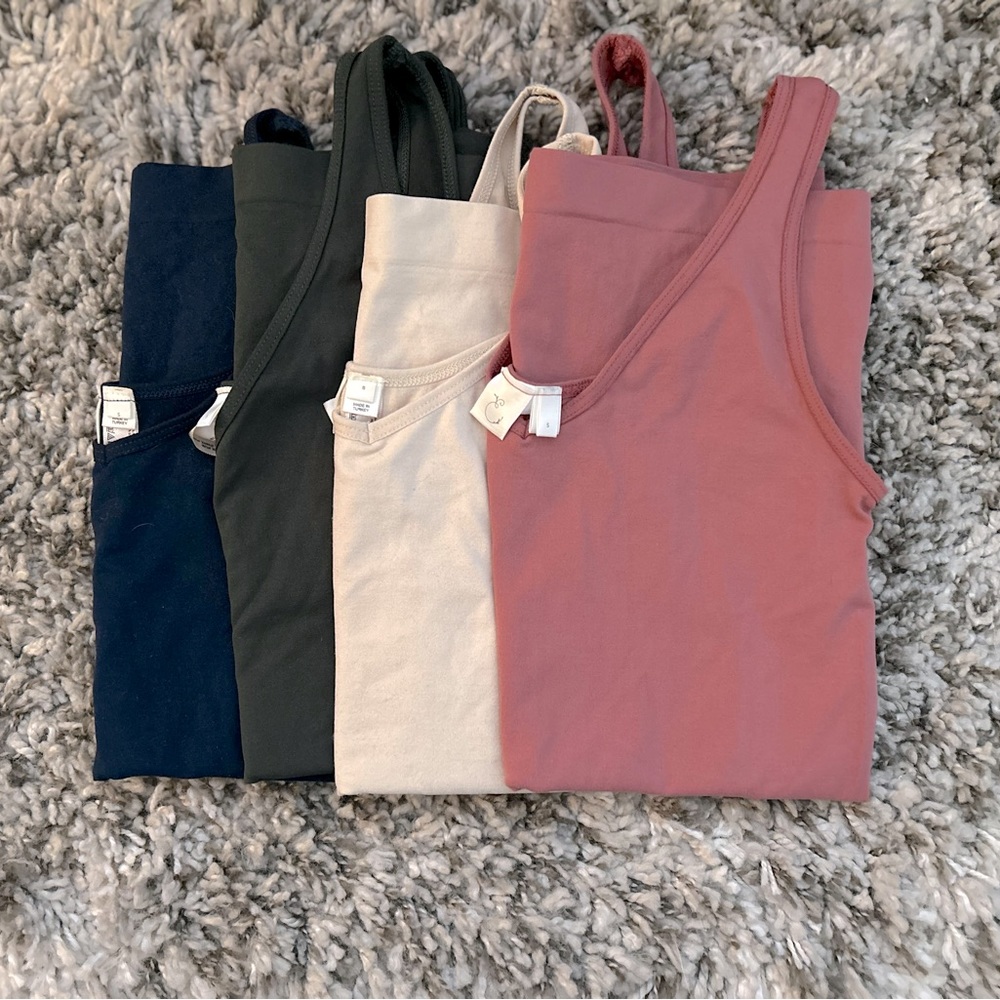 Buttery, stretchy tanks from Anthropologie! Slight v-neck / reversible to scoop.